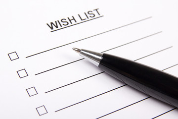 white paper with blank wish list and pen