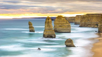 Fototapeten The 12 apostles in the sunset time in the cloudy day © gnskrw