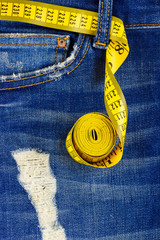 Close-up view of yellow measuring type on jeans pocket