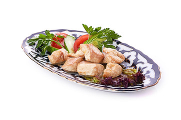 Meat on a grill with vegetables