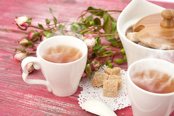 tea with sugar cubes on wooden