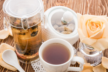 Tea cups with teapot on old wooden table