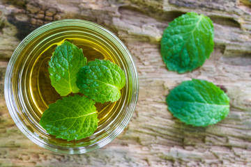 lemonade with mint on a dark wood background.