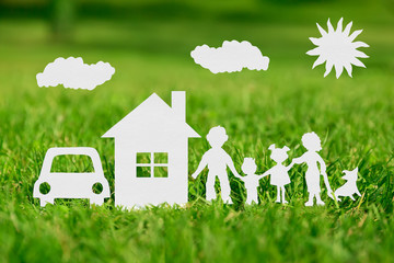 Paper cut of family with house and car on green grass - 81092024