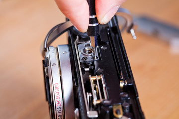 Technician repairing old photo camera