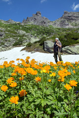 portrait of a male traveler on the alpine meadow