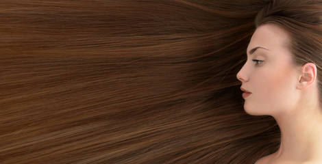 Brown hair. Beautiful young woman with  long healthy hair.