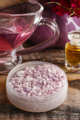 Fototapeta na wymiar Lavender sea salt and jug of pink liquid soap