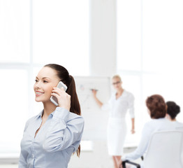 young smiling businesswoman with smartphone