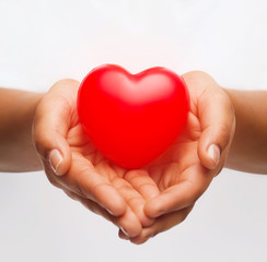 female hands with small red heart