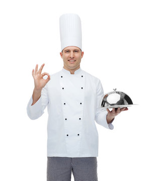 happy male chef cook with cloche showing ok sign