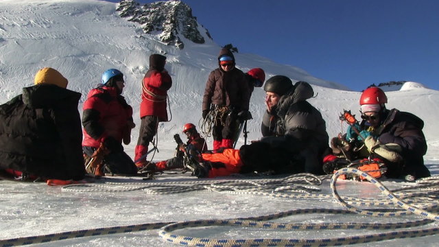 Climber resting on a glacier before climbing to the top of the mountain. Altai, in November 2015, the foot of the mountain Aktru, altitude 4000