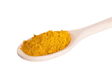 Curry seasoning in a wooden spoon, it is isolated