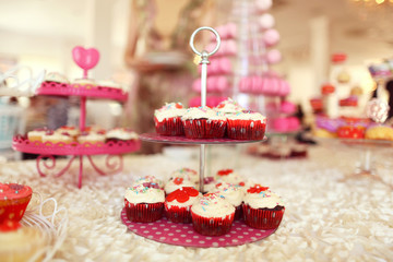Delicious cupcakes on table