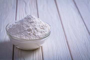 glass bowl with flouron white painted wooden board food and drin