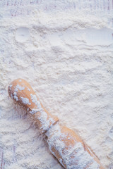 handle of wooden rolling pin on white flour food and drink still