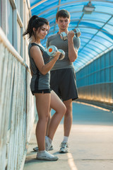 Athletic couple pumping up muscles