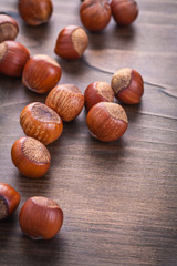 several hazelnuts on vintage wooden board food and drink concept