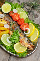 Grilled fish with vegetables on rustic table