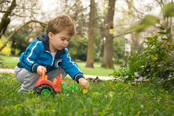Little boy playing in the grass