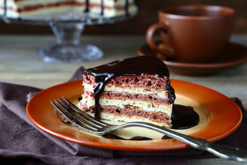 Piece of cake with hot chocolate on a plate