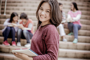 group of happy teen high school students outdoors