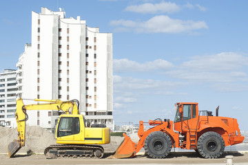 Orange and yellow excavators