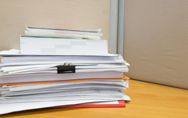 pile of documents on the office desk