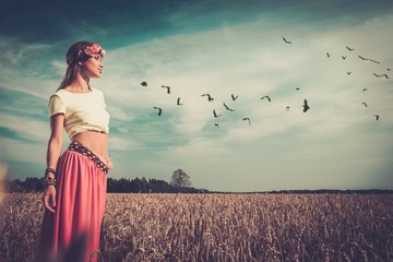 Beautiful hippie girl in a field