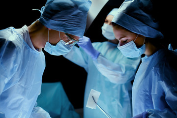 Team surgeon at work in operating room.