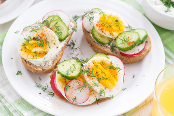 buns with boiled egg and vegetables, top view, close-up