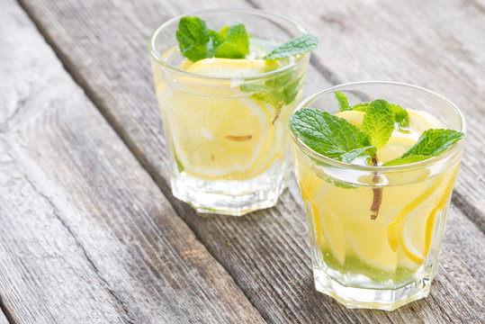 refreshing mint lemonade in glasses on a wooden background
