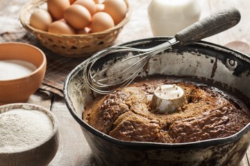 cake in form with ingredients-milk, flour, eggs and sugar on the