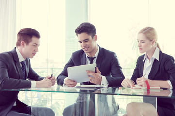 business partners discussing documents and ideas at meeting