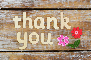 Thank you written with wooden letters on rustic wooden surface