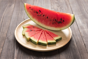 Fototapeta na wymiar watermelon on a wood background.