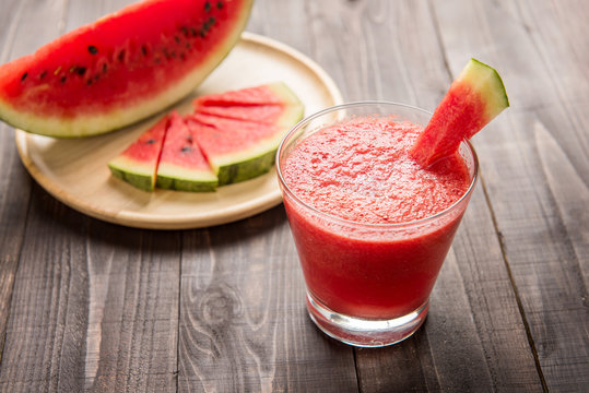 Healthy watermelon smoothie on a wood background.