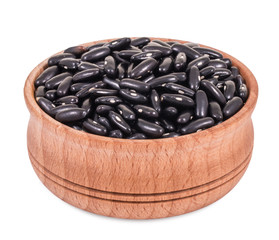 Purple beans in a wooden bowl isolated on white background