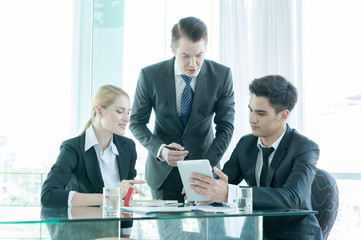 business partners discussing documents and ideas at meeting