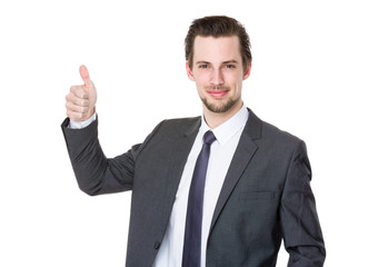 Smiling businessman with thumb up