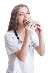 Female doctor taking a lot of blisters of pills