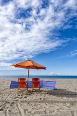 Lounge Chairs and Umbrella at the Beach