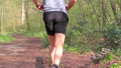 Young man doing push up in forest