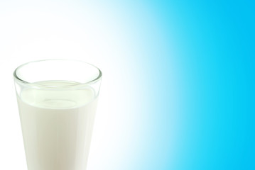 white cow milk in drinking water glass on blue ground