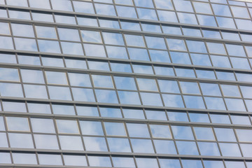 The glass facade of a tall building