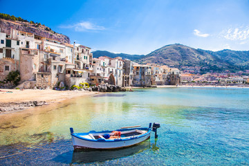 Old harbor with wooden fishing boat in Cefalu, Sicily - obrazy, fototapety, plakaty