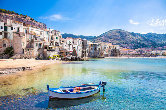 Old harbor with wooden fishing boat in Cefalu, Sicily