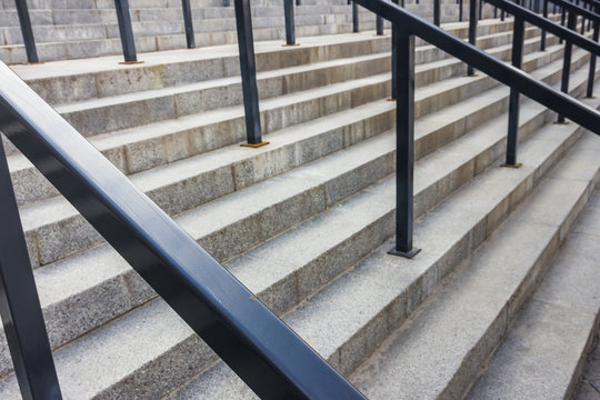 Stone steps with black metal railing