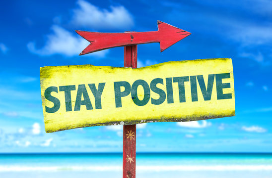 Stay Positive sign with beach background
