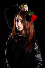 Beautiful young woman with chains and a red rose